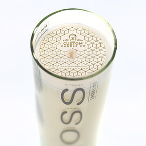 Top view of the Recycled Voss Sparkling Water Candle in a glass container with a geometric-patterned lid and visible wooden wick.