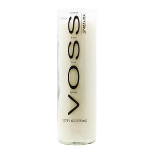A clear Voss bottle labeled "Voss Sparkling Water, 12.7 FL OZ (375 mL)" is repurposed as the Recycled Voss Sparkling Water Candle, made from natural soy wax for a unique sparkling water candle design.