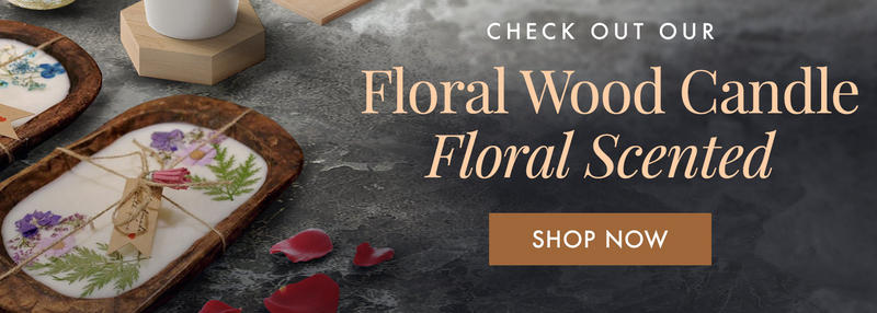 Floral wood candle set with decorative elements on a dark surface, featuring a 'Shop Now' button.