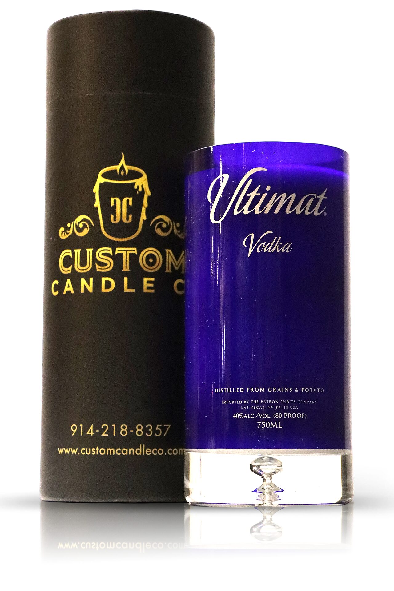 A blue Recycled Vodka Candle - Ultimat next to a box, enhanced by the presence of an exquisite ultimat vodka.