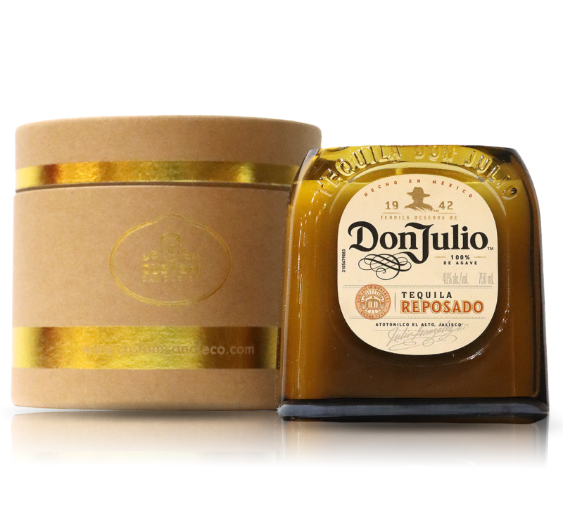 A box of recycled Don Julio Reposado Tequila Candle next to a gold box.