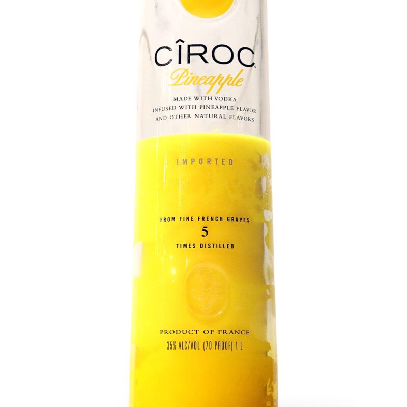 A Recycled Vodka Candle - Ciroc Pineapple with yellow liquid.
