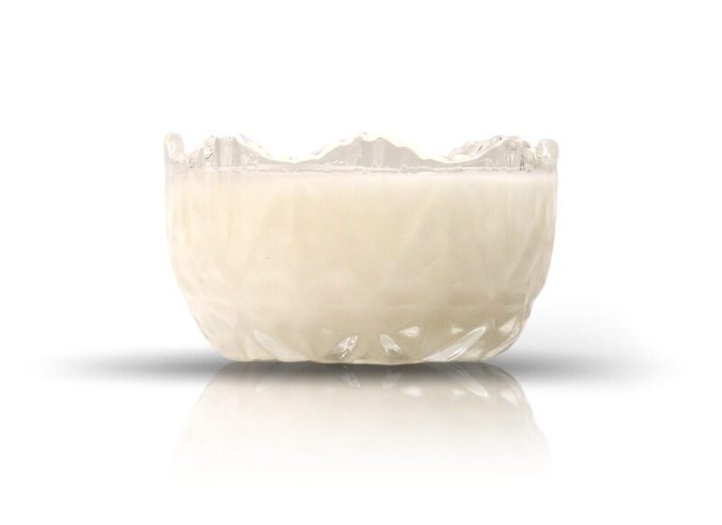 A Clear Glass Sugar Dish Candle on a white surface.