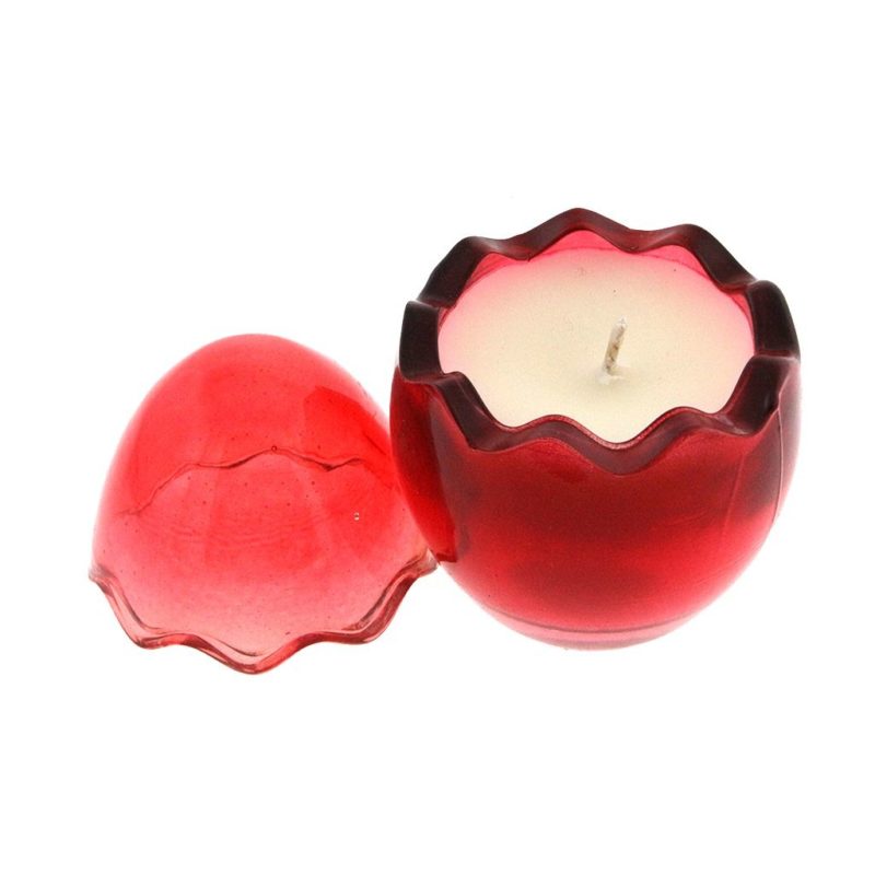 A Red Glass Easter Egg candle holder with a white wax candle inside