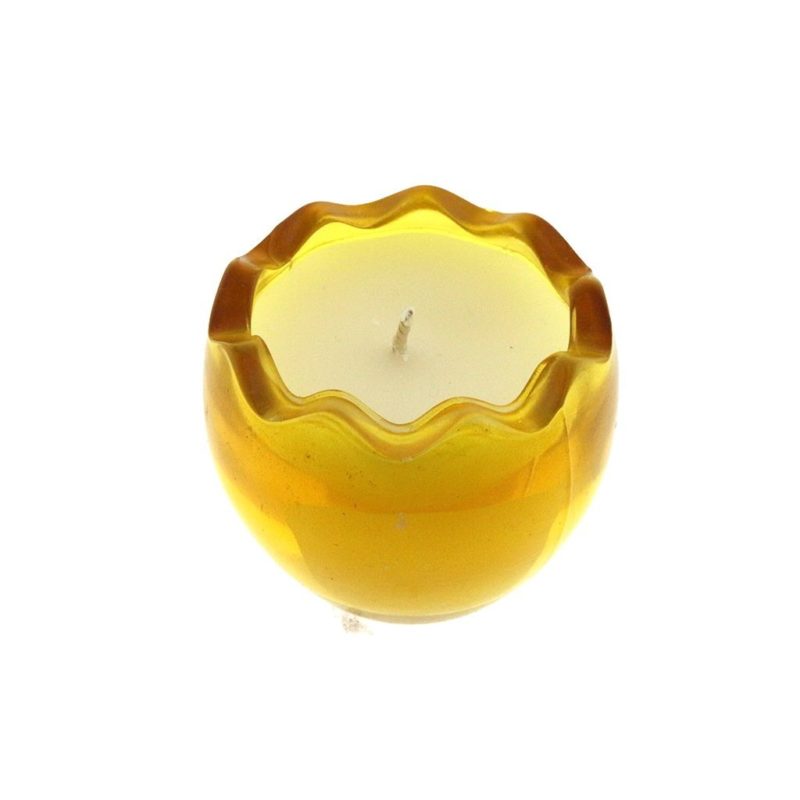 A Yellow Glass Easter Egg candle is sitting on a white surface. Photo is of the top view.