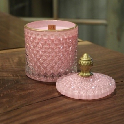 An Elegant Pink Crystal Scented Candle with a gold lid.