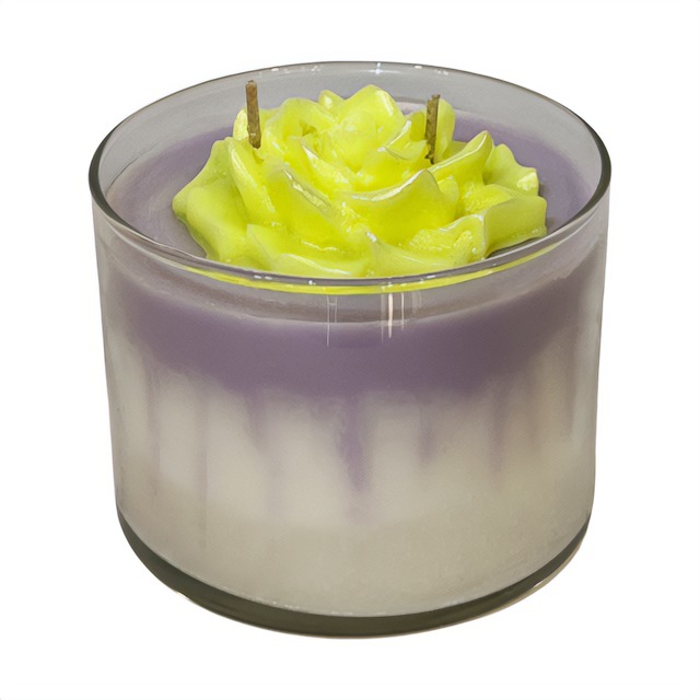 A Green Tie - Dye candle with a Pink Flower in it, scented with Floral fragrance.
