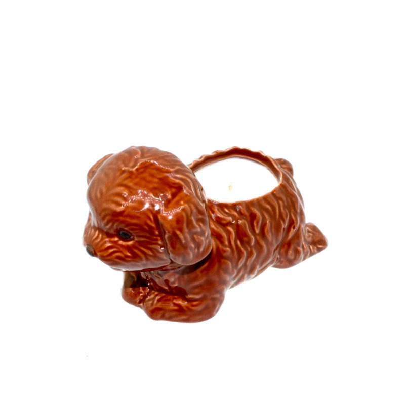 A Brown Puppy Candle holder with the dog pointing towards the left side.