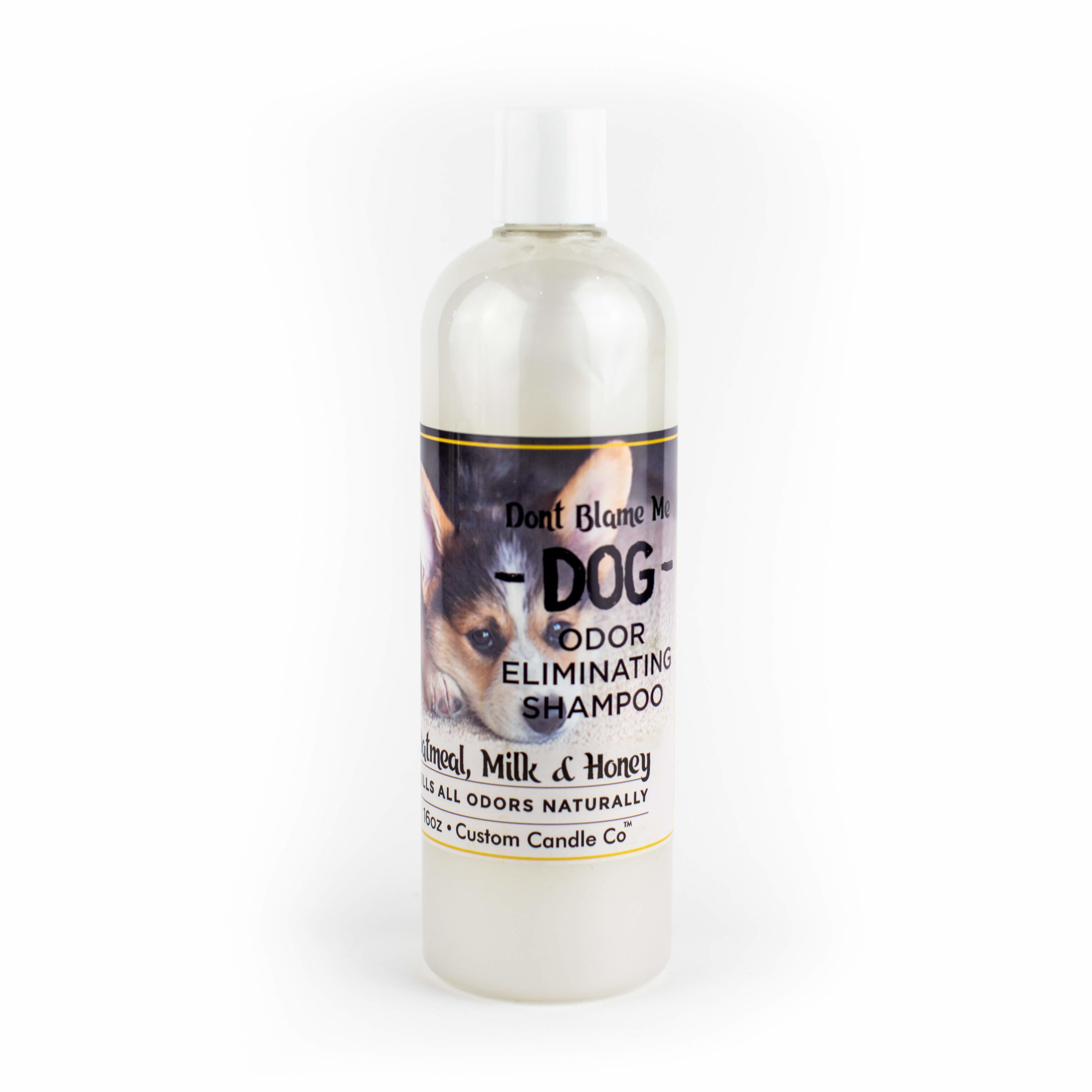 A bottle of Dog Shampoo - Oatmeal Milk Honey 16oz on a white background.