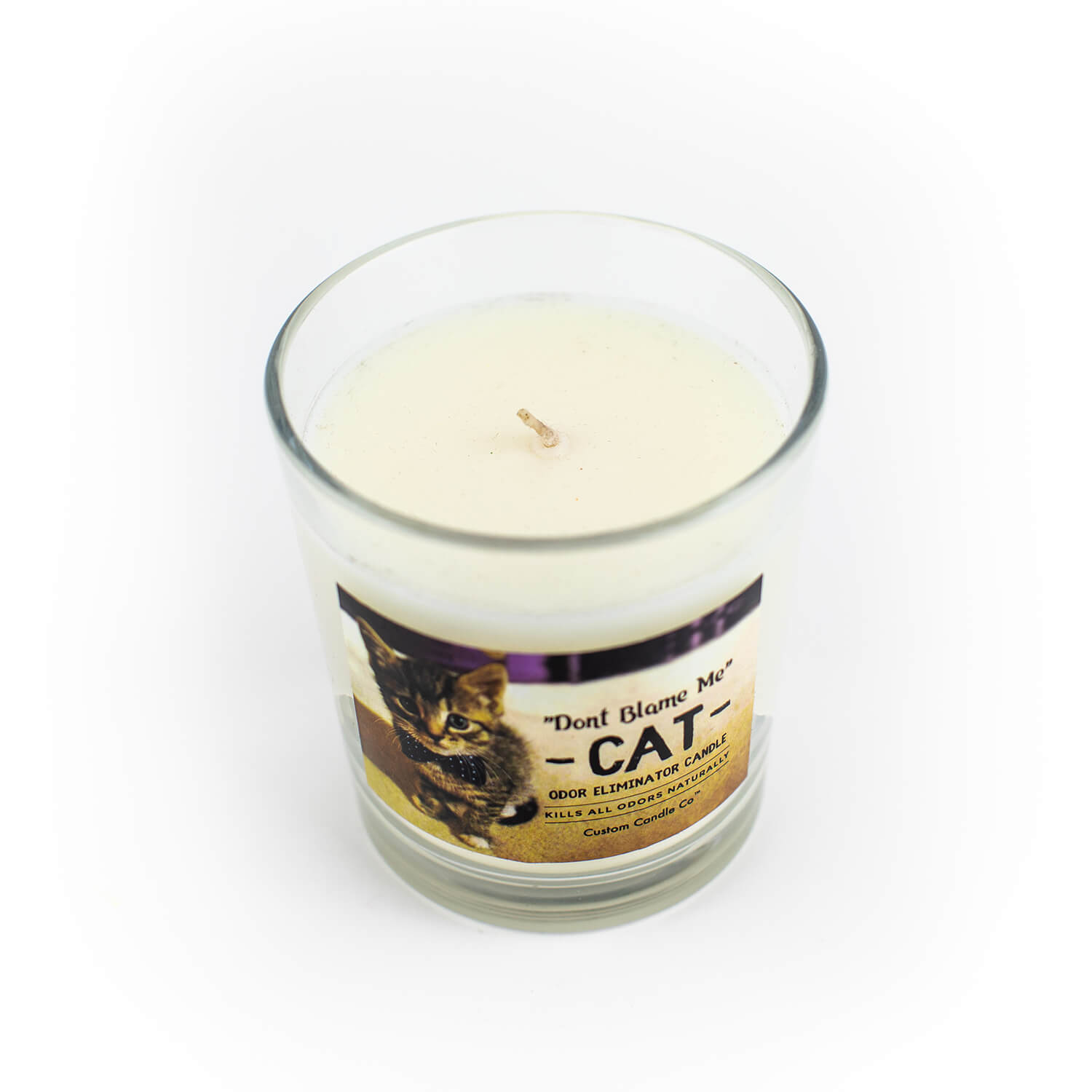A "Don't Blame Me" Cat Candle Odor Eliminator with a cat on it on a white background.