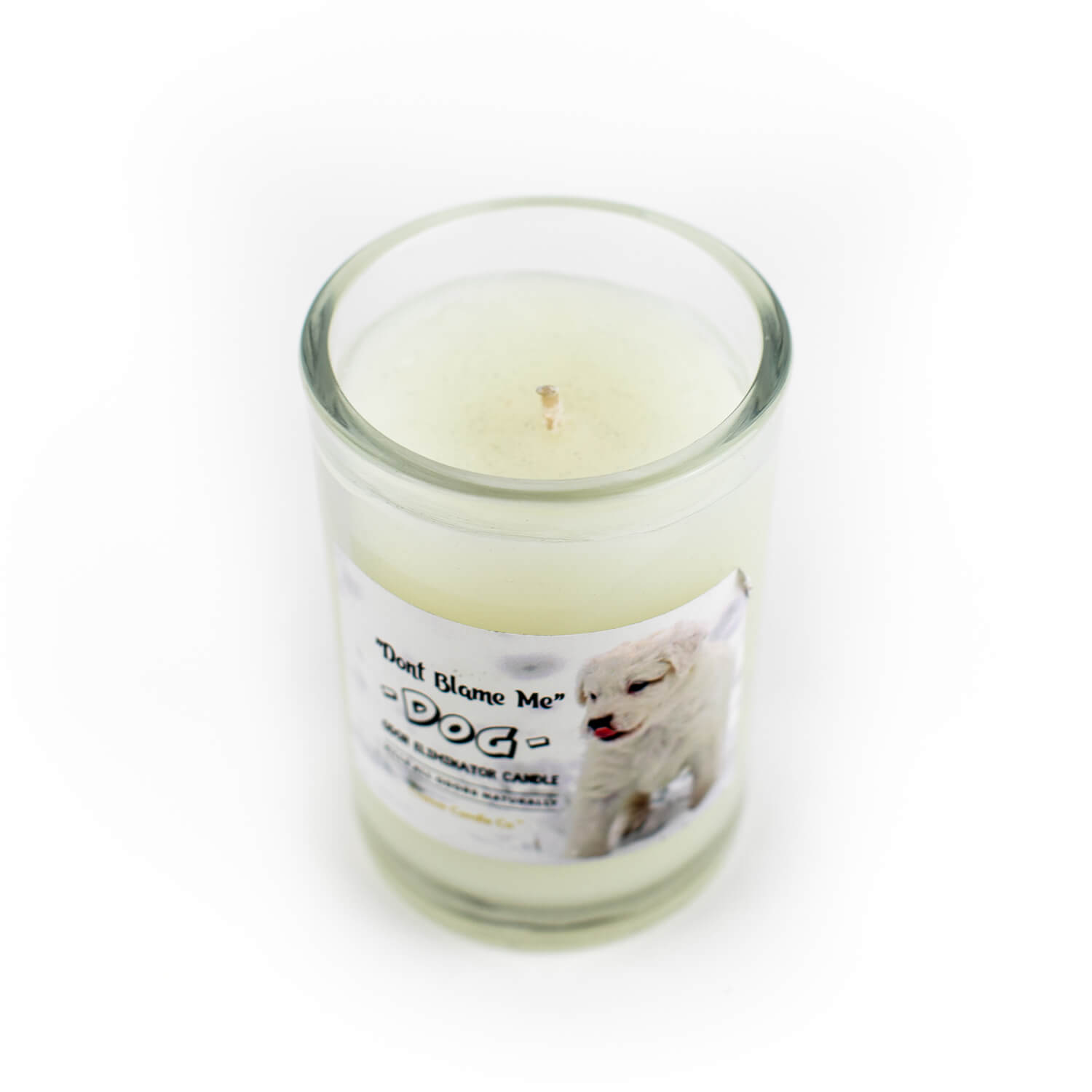 A "Don't Blame Me" small Dog Candle Odor Eliminator with a picture of a dog on it.
