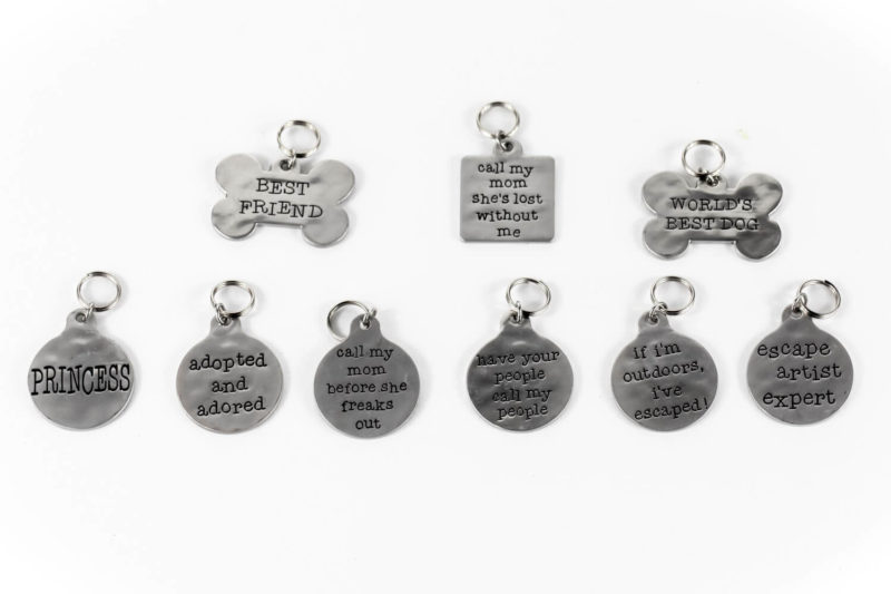 A group of Funny Quote Pet Tags with different sayings on them.