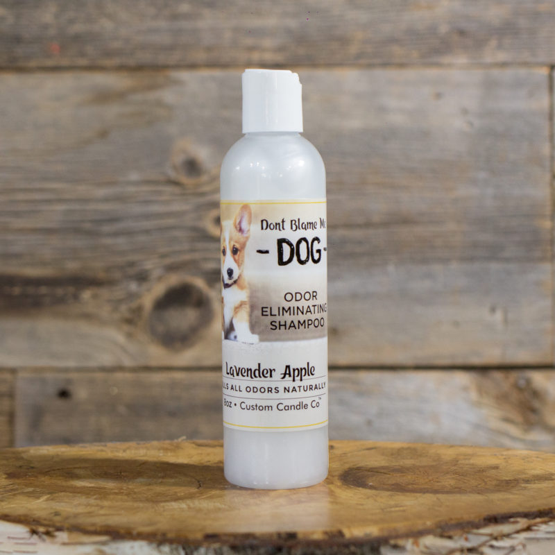 A bottle of Dog Shampoo - Lavender Apple 8-oz sitting on a wooden table.