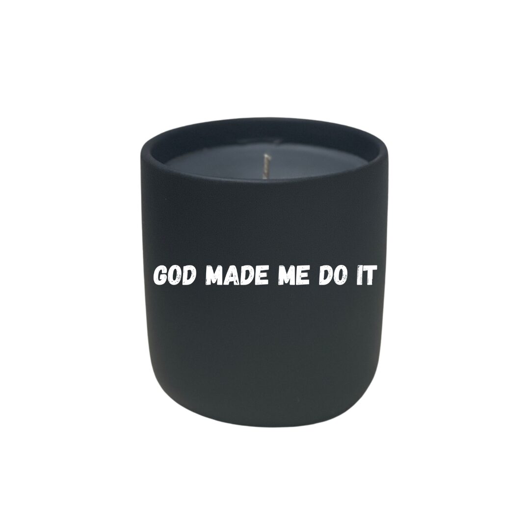 A black Quoted Candle - God Made Me Do It elegantly printed.
