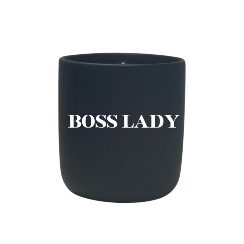 A black candle with the word "boss mom" quoted on it.